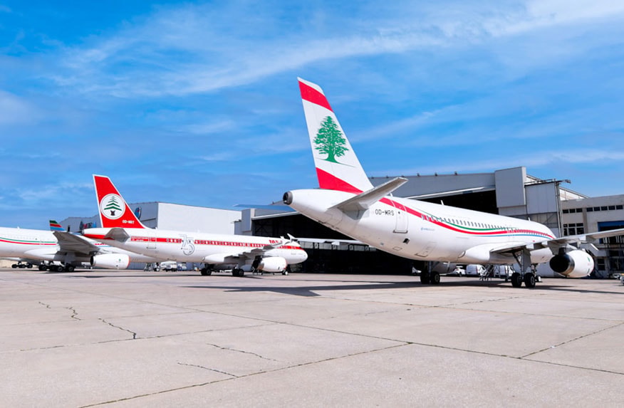 A Middle East Airlines aircraft on the tarmac at Beirut Rafic Hariri International Airport with the city skyline in the background