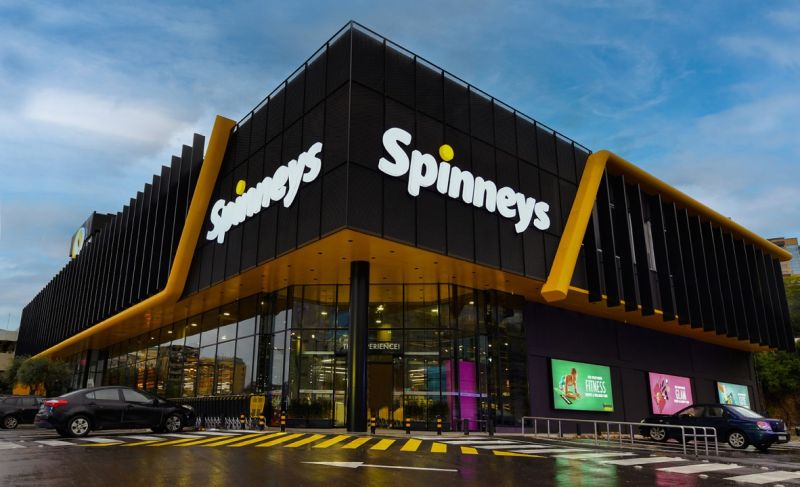 Exterior of a Spinneys supermarket in Lebanon with branded signage above the entrance and shoppers walking in