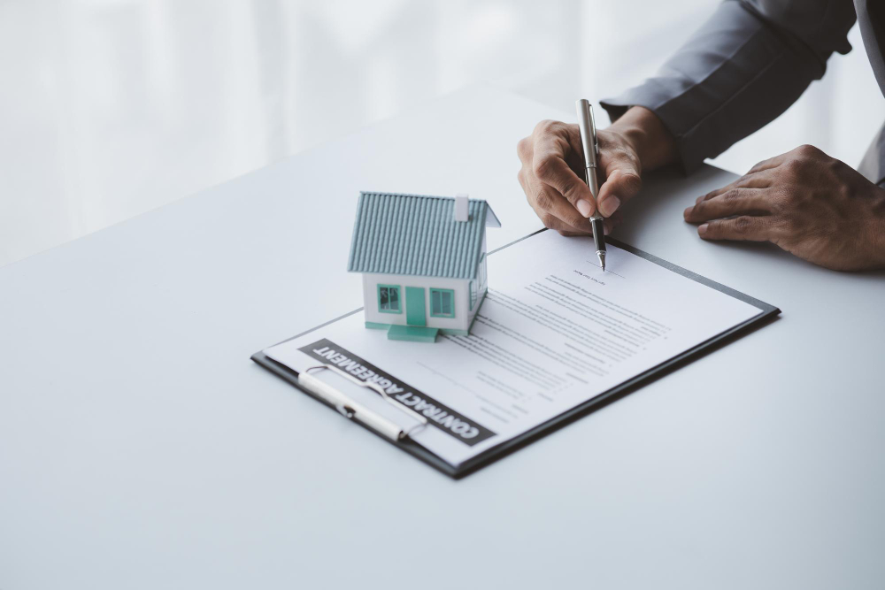 A property title deed and keys on a desk
