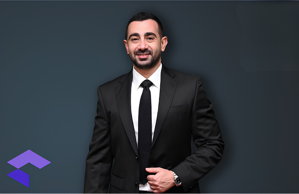 Fares Saab, founder of CompuVision, in the company's Lebanon office, with the CompuVision logo visible infront of him.