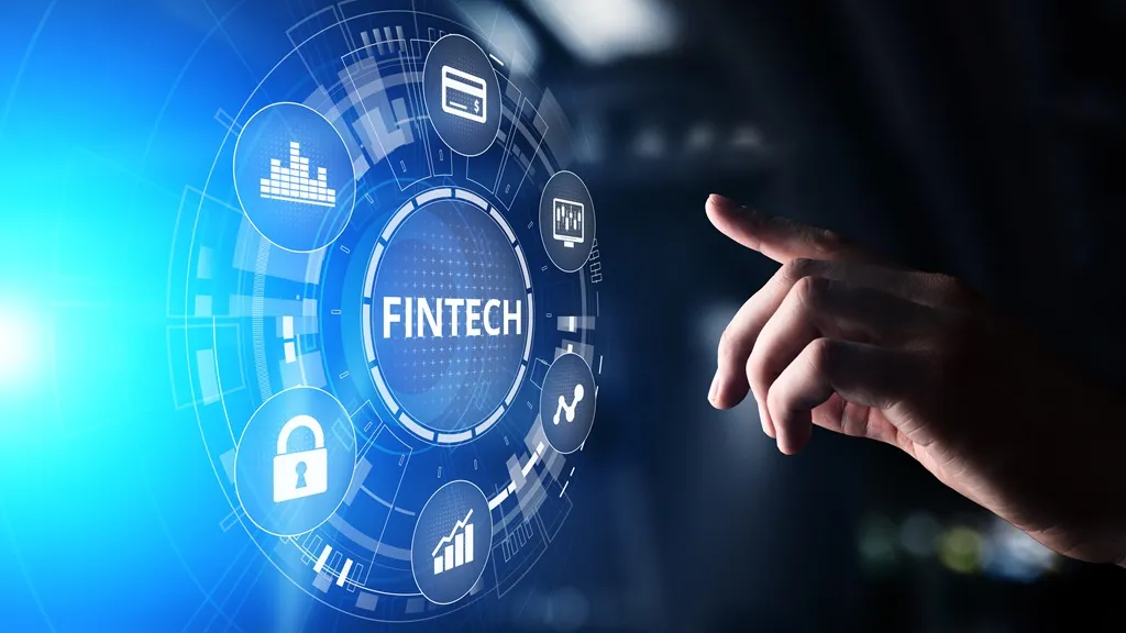 A hand touching a glowing blue digital interface with the word FINTECH at the center, surrounded by icons for payments, security, charts and growth.