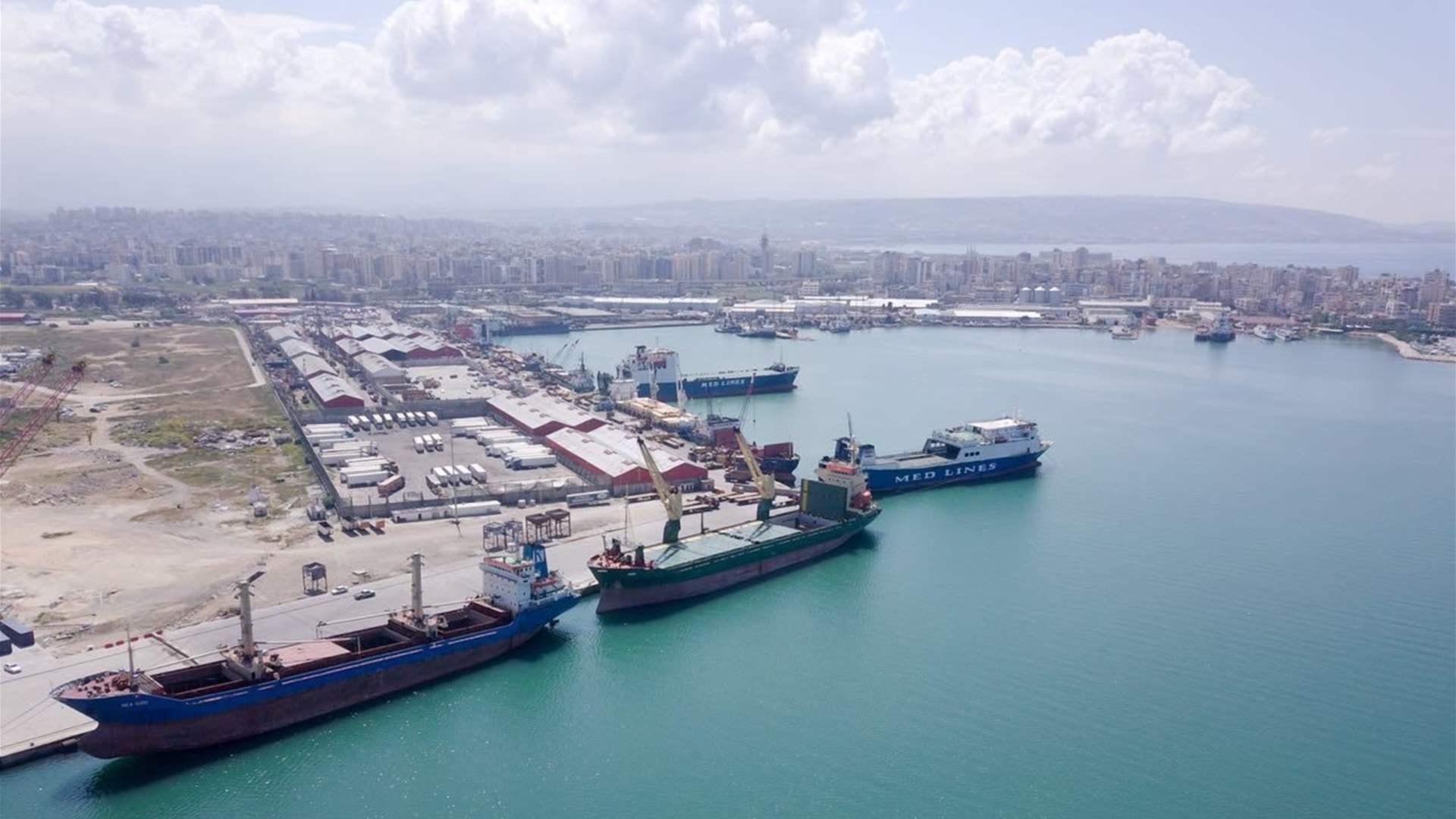 Cargo cranes and container ships docked at the Port of Tripoli in northern Lebanon