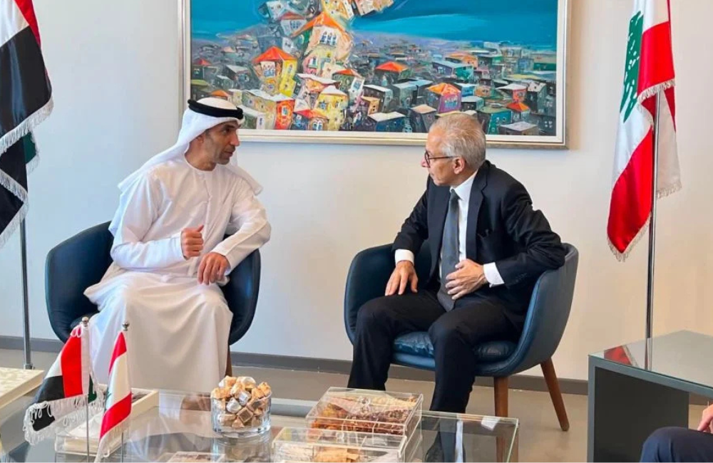 UAE Minister of State for Foreign Trade Thani bin Ahmed Al Zeyoudi in talks with a Lebanese official in Beirut, flanked by the UAE and Lebanon flags
