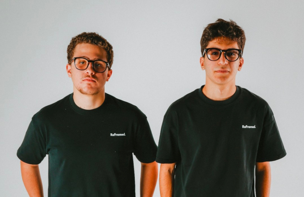 ReFramed founders Jason Azzi and Jad Chabtini in black ReFramed t-shirts against a plain gray background.