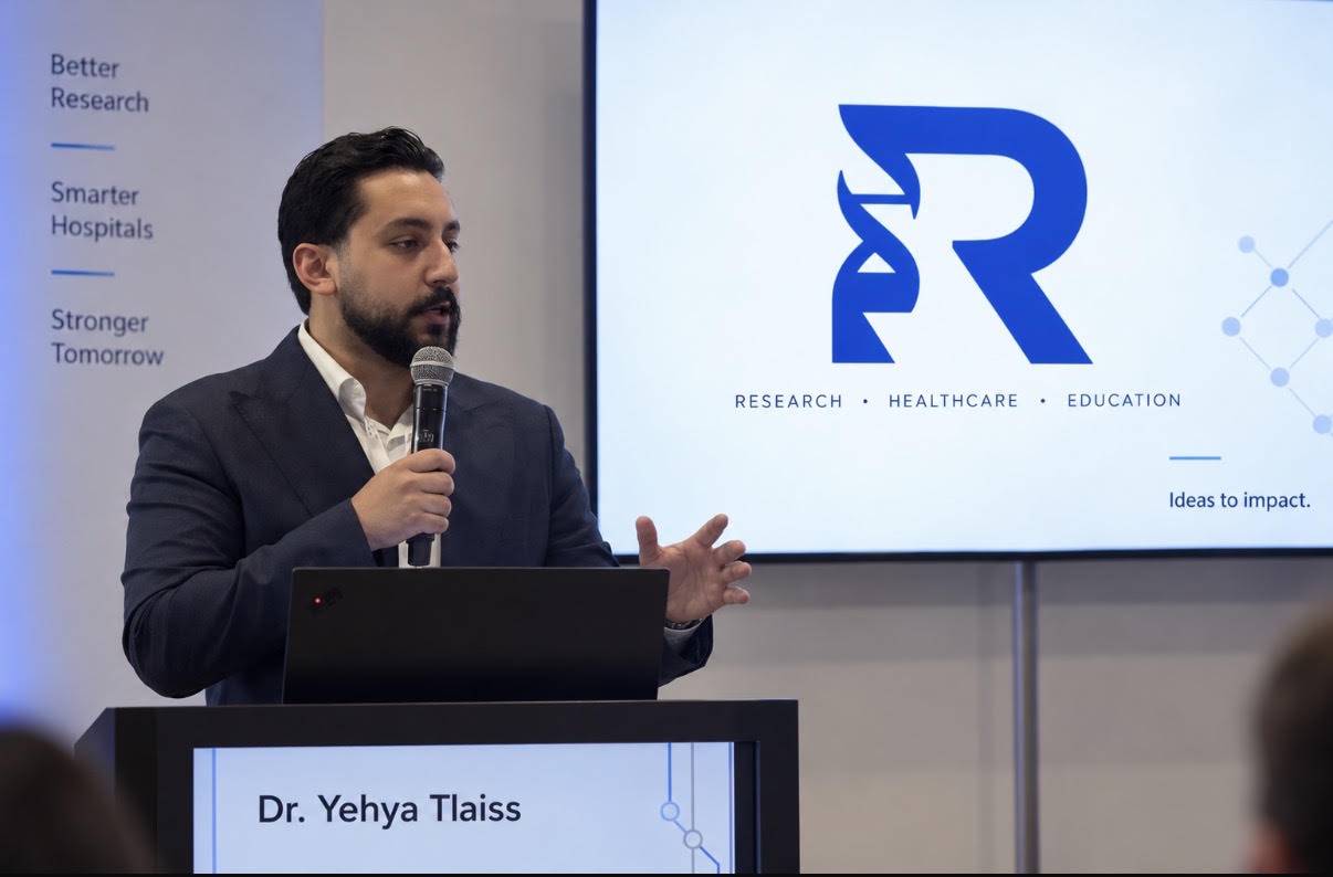 Dr. Yehya Tlaiss, founder of R-Chief Labs, speaking at a podium beside a screen showing the R-Chief logo and the words Research, Healthcare, Education