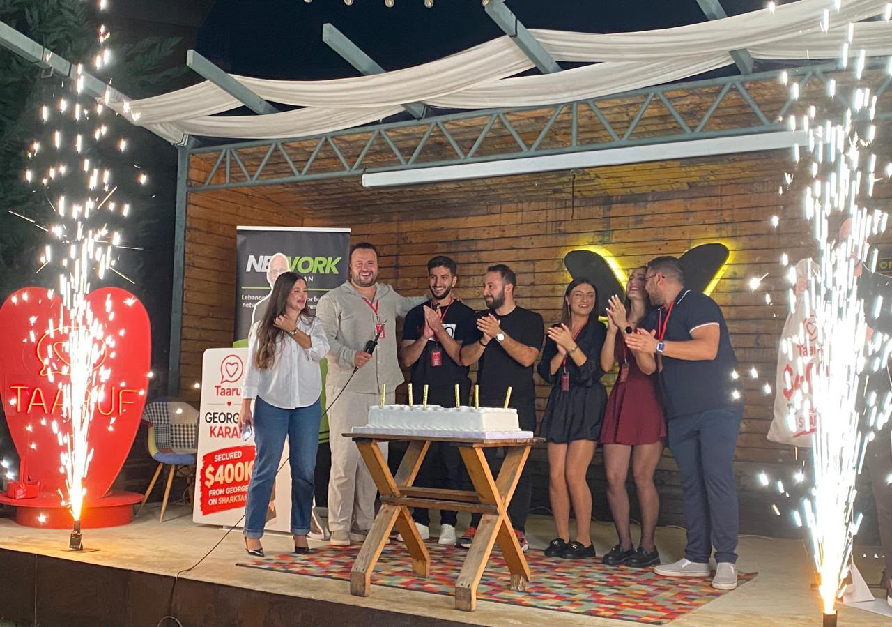 The Taaruf team celebrates on stage with a cake, surrounded by sparkler fountains, next to a Taaruf heart sign and a banner about the $400K Shark Tank Lebanon offer.